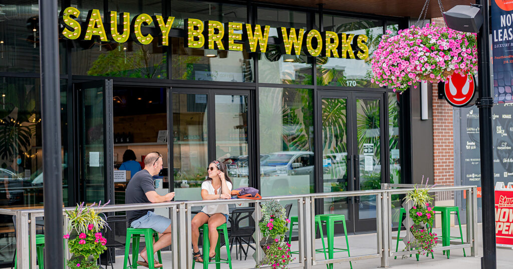 Saucy Brew Works Pinecrest exterior with guests drinking beer