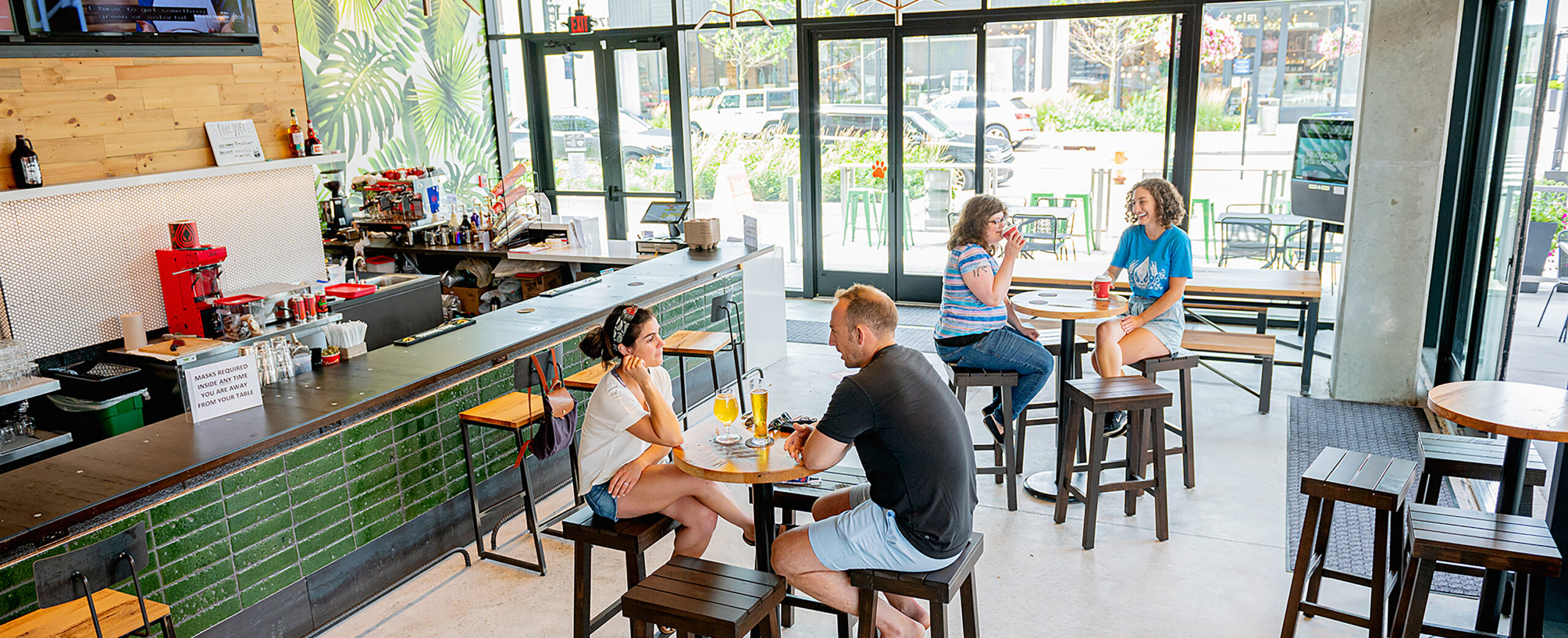 Guests enjoying drinks inside the Saucy Pinecrest brewpub