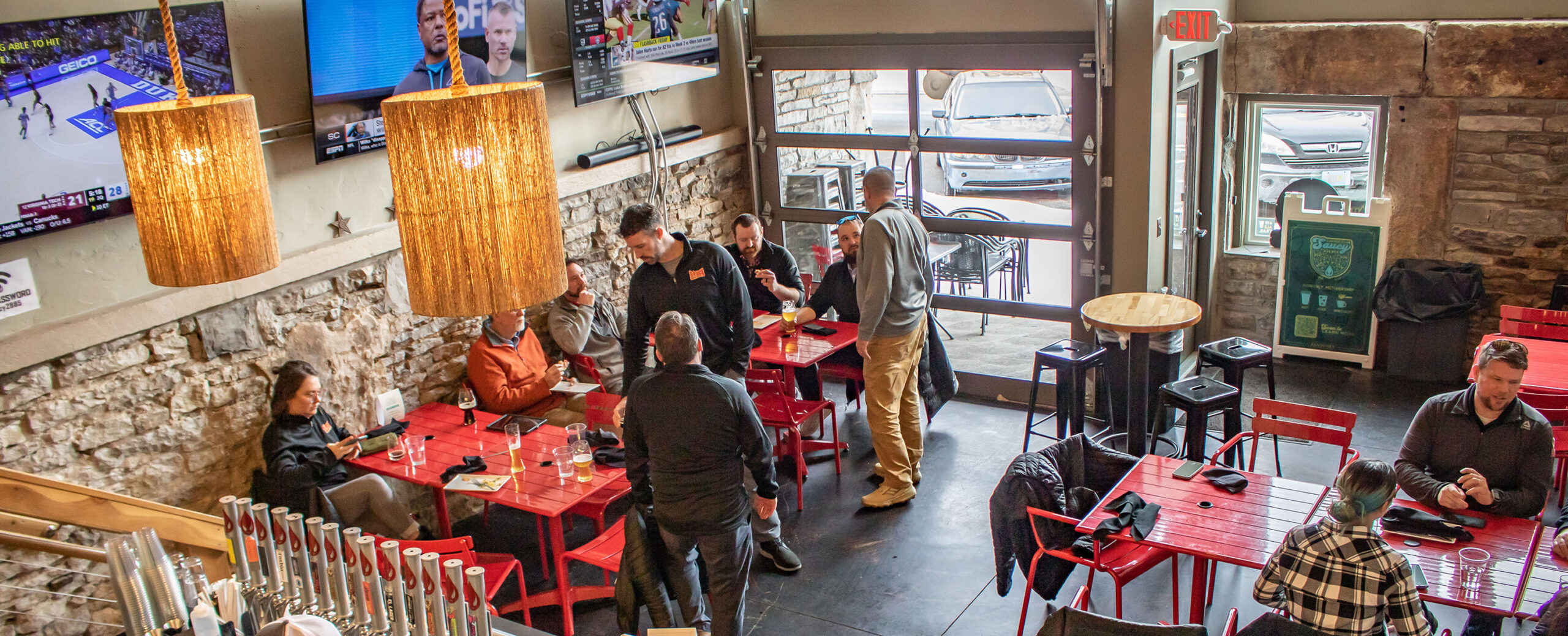 Guests enjoying food and beer in the Saucy Sandusky garage bar
