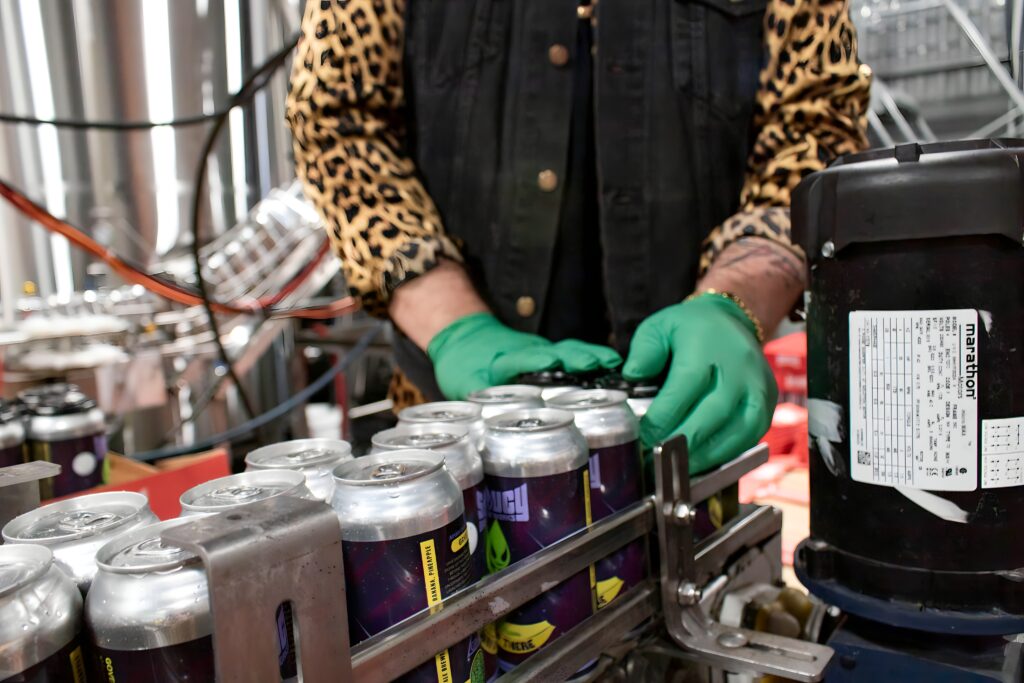 Beer canning line with guy packaging beer.